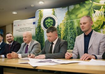 Za stołem siedzi czterech mężczyzn. Wśród nich jest marszałek województwa lubelskiego Jarosław Stawiarski oraz wicemarszałek Marek Wojciechowski oraz dwóch przedstawicieli Stowarzyszenia Polskich Plantatorów Chmielu w Wilkowie