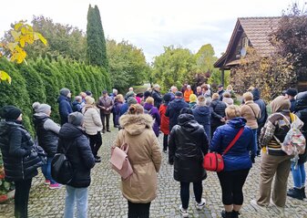 Uczestnicy wyjazdu studyjnego pod nazwą „Gospodarstwa ekologiczne” na Podlasie zwiedzają gospodarstwo państwa Romaniuków w Nowokornino. Jest to grupa licząca 50 osób. Stoją na podwórku, po prawej stronie jest dom, po lewej żywopłot. Gospodarz opowiada o pracy na swoim gospodarstwie